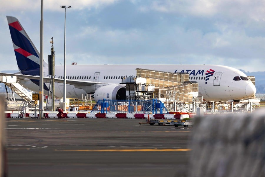The Latam Airlines Boeing 787 Dreamliner plane that suddenly lost altitude mid-flight a day earlier, dropping violently and injuring dozens of terrified travellers, is seen on the tarmac of the Auckland International Airport in Auckland. - AFP PIC