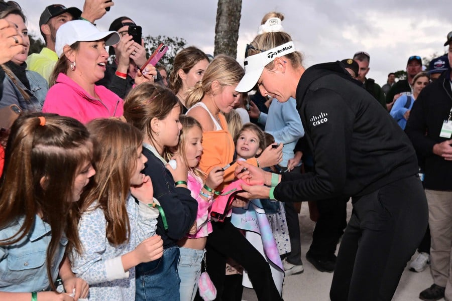 Nelly Korda of the United States signs autographs after a victory on the second play-off hole during the final round of the LPGA Drive On Championship at Bradenton Country Club in Bradenton, Florida. -AFP PIC
