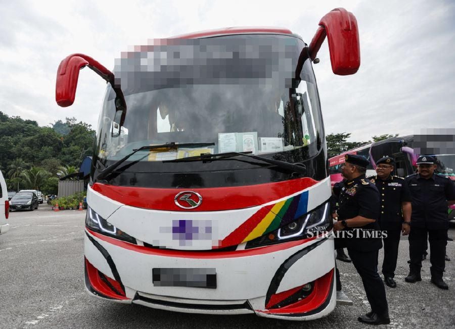 Road Transport Department (RTD) Senior Enforcement Director Muhammad Kifli Ma Hassan (right) inspecting one of the busses during the operation at the Gombak RTD Enforcement Station at the Kuala Lumpur-Karak Highway. -NSTP/ASWADI ALIAS