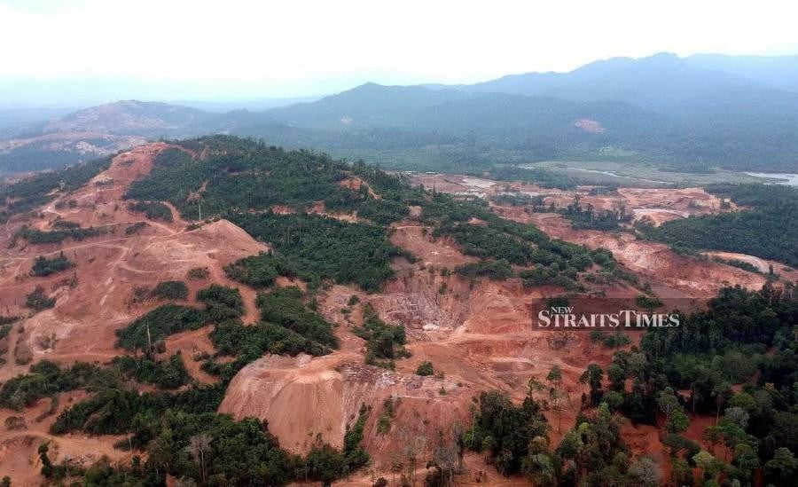 This file pic dated June 15 shows the mining and deforestation activities taking place around Bukit Kampung Melai, Tasik Chini. -NSTP/FARIZUL HAFIZ AWANG