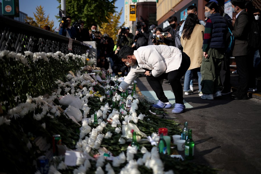 A man pays tribute near the site of a stampede that happened during Halloween festivities in Seoul, South Korea. - REUTERS PIC