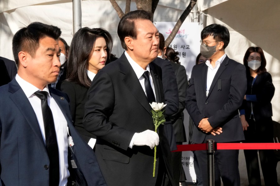 South Korean President Yoon Suk Yeol, center, arrives to pay tribute for victims of a deadly accident following Saturday night's Halloween festivities, at a joint memorial altar at Seoul Square in Seoul, South Korea. - AFP PIC