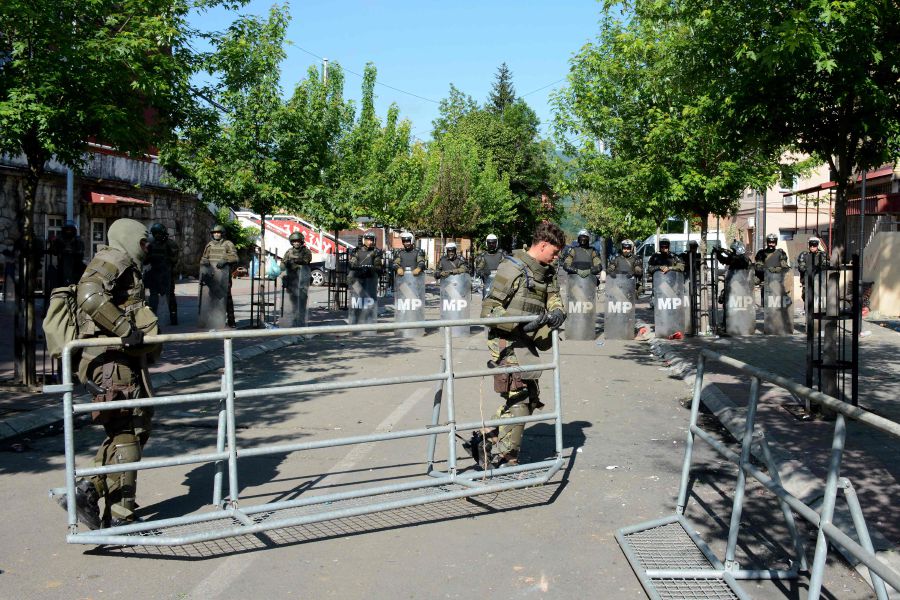 The NATO-led Kosovo Force (KFOR) soldiers, wearing full riot gear, place metal fences around the municipal building in Zvecan, northern Kosovo on May 30, 2023, a day following clashes with Serb protesters demanding the removal of recently elected Albanian mayors. The situation in northern Kosovo remained tense on May 30, 2023, as ethnic Serbs continued to gather in front of a town hall in Zvecan after violent clashes with NATO-led peacekeepers left 30 soldiers injured. - AFP pic