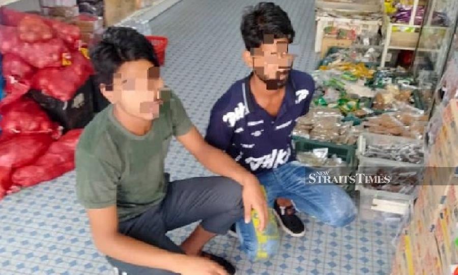The duo were among five foreigners nabbed during the operation at Jalan Hilir Pasar in Kota Baru. - Pix courtesy of Immigration Dept