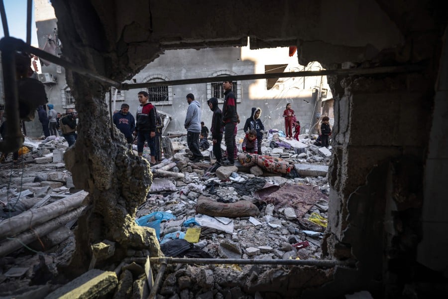 People inspect the damage following Israeli bombardment in Rafah on the southern Gaza Strip. - AFP PIC