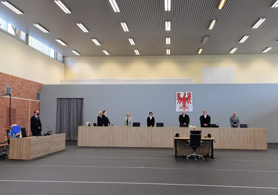 Presiding judge Udo Lechtermann (3rd R) and other judges are pictured before the opening of a trial against defendant Josef S (L) sitting next to his lawyer Stefan Waterkamp (2nd L) in Brandenburg an der Havel, northeastern Germany. - AFP PIC