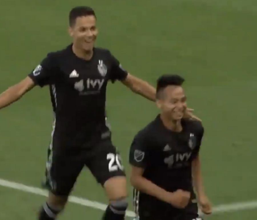 Wan Kuzain (front) celebrates his goal with a teammate. 