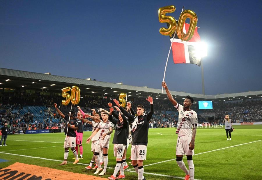 Leverkusen players display a ‘50’ marking their 50th unbeaten game of the season after the Bundesliga match against VfL Bochum on Sunday. - AFP PIC