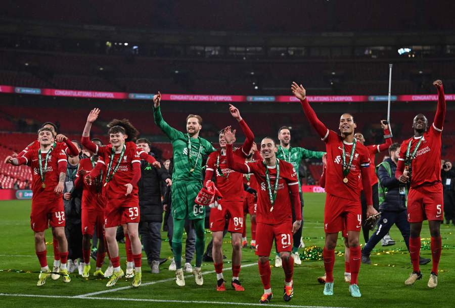 Liverpool's Irish goalkeeper #62 Caoimhin Kelleher (L and Liverpool's Dutch defender #04 Virgil van Dijk (2R) celebrate with teammates following the English League Cup final football match between Chelsea and Liverpool at Wembley stadium, in London, on February 25, 2024. - AFP pic