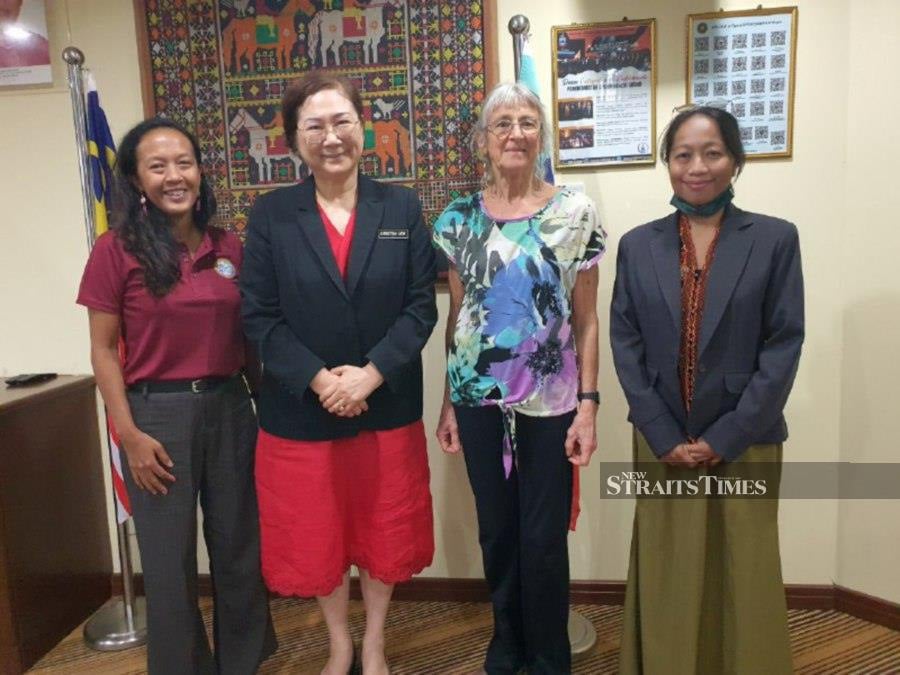 Sabah Tourism, Culture and Environment minister Datuk Christina Liew (second left) taking a group photo with representatives from Semporna Islands project at the Ministry's office in Kota Kinabalu. - Pic courtesy of Sabah Tourism, Culture and Environment Minister.