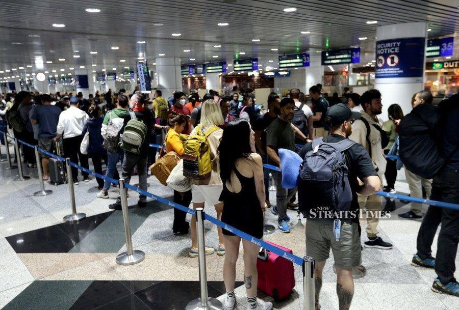 The long lines at the Immigration counters at the Kuala Lumpur International Airport (KLIA) on Saturday were due to a large number of aircraft arrivals.  - NSTP/MOHD FADLI HAMZAH