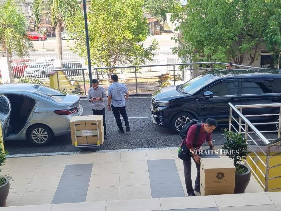 The Malaysian Anti-Corruption Commission (MACC) officers with some seized items related to the Air Kelantan Sdn Bhd (AKSB) investigation. 