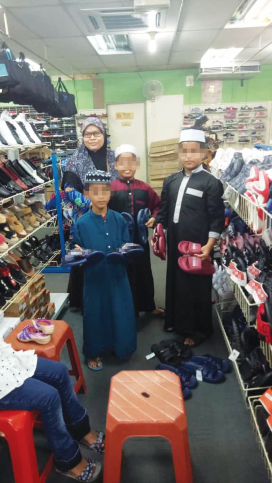 Kak Zalina and some of the refugee children buying slippers.