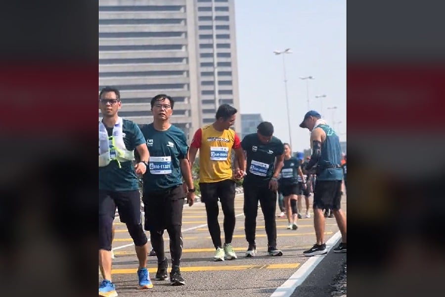 A runner who was seen supporting his fellow runner to make it to the finish line of the Kuala Lumpur Standard Marathon last weekend has shown the true meaning of camaraderie among sportsmen. - Screengrab fromTikTok