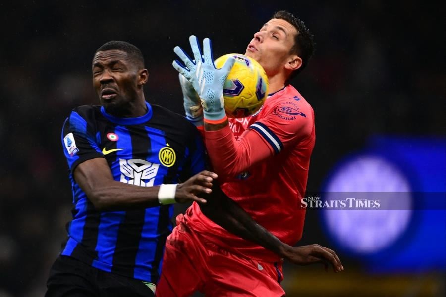 Inter Milan's Marcus Thuram (left) fights for the ball with Udinese goalkeeper Marco Silvestri during their Serie A match at the San Siro Stadium in Milan on December 9, 2023. AFP PIC 