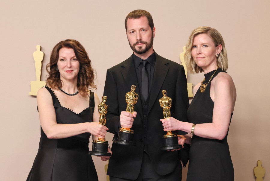  (L-R) Raney Aronson-Rath, Mstyslav Chernov, and Michelle Mizner, winners of the Best Documentary Feature Film for ‘20 Days in Mariupol’, pose in the press room during the 96th Annual Academy Awards at Ovation Hollywood in Hollywood, California. - AFP PIC