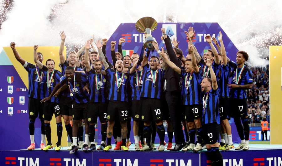 Inter Milan players celebrate after winning the Serie A on May 19 at the San Siro.-REUTERS PIC