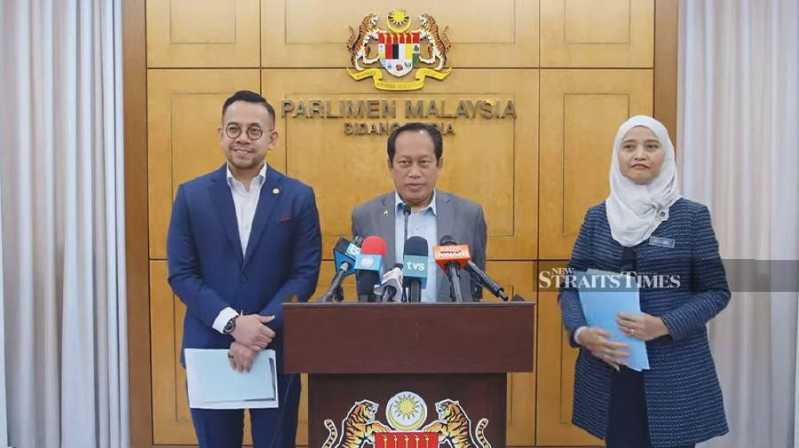 Deputy Finance Minister I Datuk Seri Ahmad Maslan (centre) addressing the media during a press conference at Parliament today. 