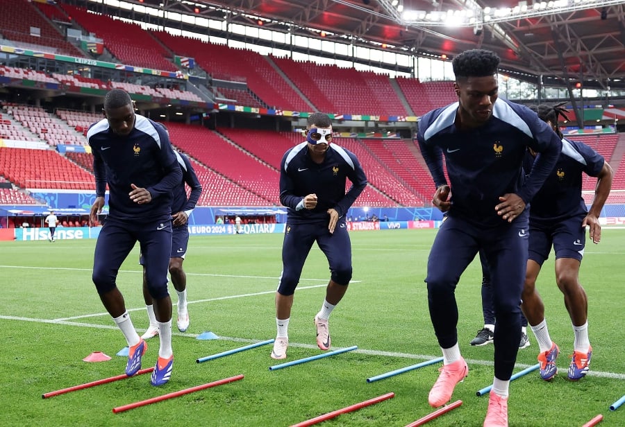 France’s Kylian Mbappe (centre) wears a face mask as he takes part with teammates in a training session at the Leipzig Stadium in Leipzig on Thursday. - AFP PIC