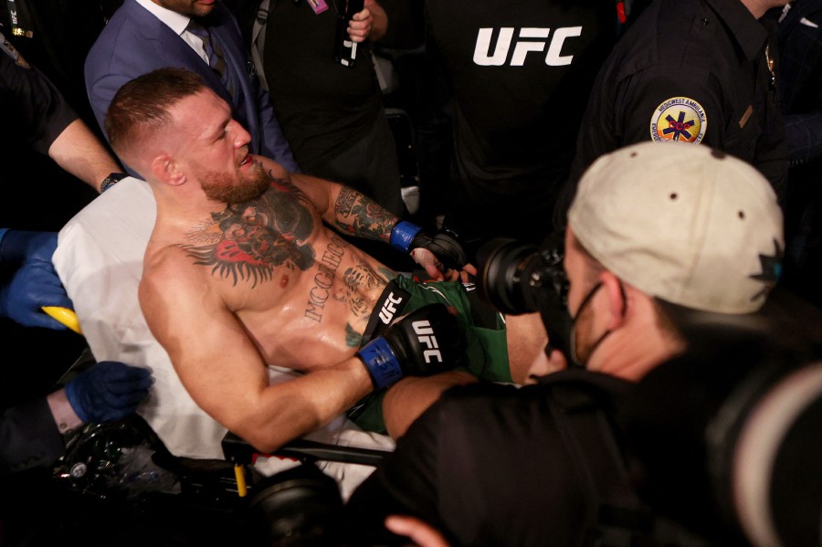  Conor McGregor of Ireland is carried out of the arena on a stretcher after injuring his ankle in the first round of his lightweight bout against Dustin Poirier during UFC 264: Poirier v McGregor 3 at T-Mobile Arena on July 10, 2021 in Las Vegas, Nevada. - AFP Pic