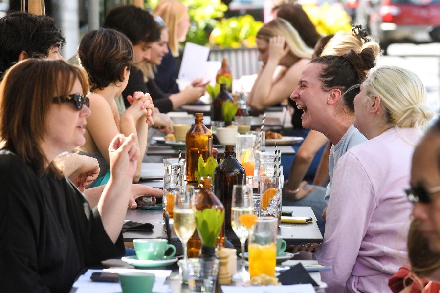 People enjoy a meal at a cafe in Melbourne on October 22, 2021, following the midnight lifting of coronavirus restrictions in one of the world's most locked-down cities. - AFP PIC