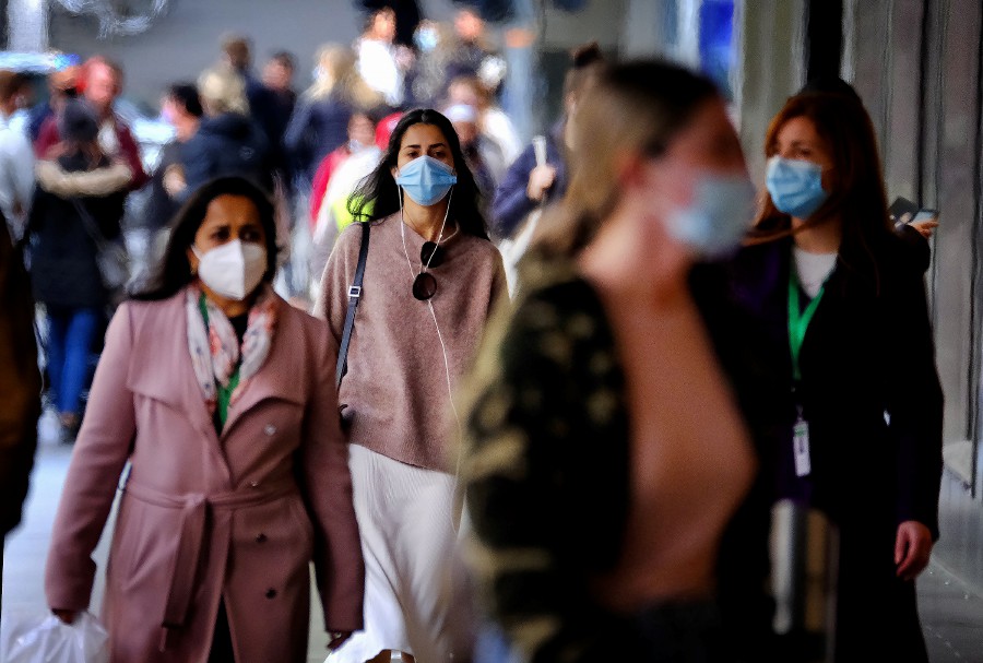  People wearing face masks walk in the CBD of Melbourne, Victoria, Australia. - EPA Pic