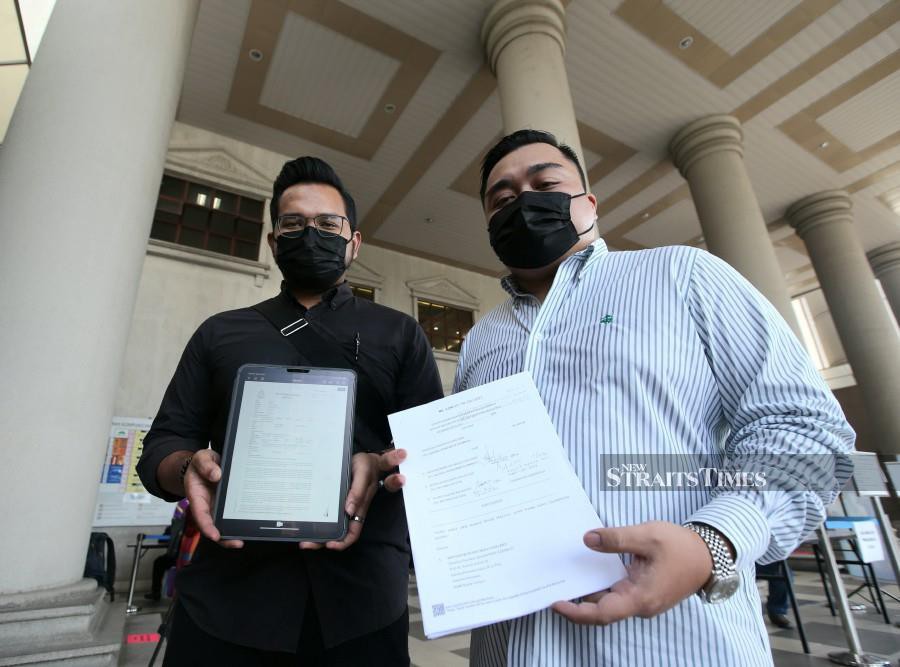 Duo charged with conning businessman out of RM7m for gloves which 