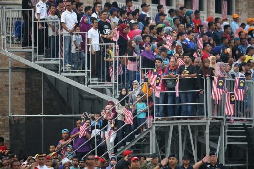 The public who thronged Dataran Merdeka for the celebration were seen clapping and waving the Jalur Gemilang. Pix by Osman Adnan