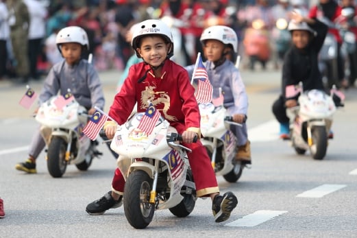 The little bikers lead the motorised contingent during the Merdeka Parade march at Dataran Merdeka. Pix by Salhani Ibrahim