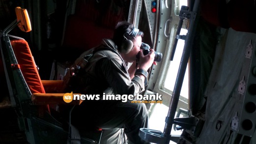 13 March 2014. Royal Malaysian Air Force personnel Zulhelmi Hassan taking pictures of the search area where Malaysia Airlines flight MH370 is believed to have disappeared. Pix by Shahrul Redzuan Zulkifli