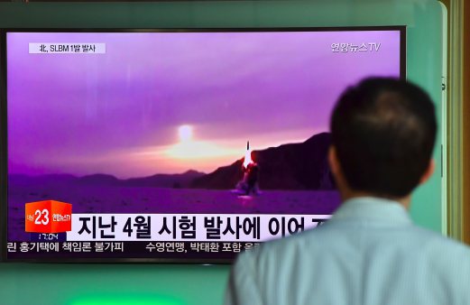 (File pix) A man watches a file footage of a North Korean missile launch. North Korea test-fired three ballistic missiles on Tuesday, South Korea’s military said, just over a week after issuing threats to respond to the planned deployment of a US anti-missile system in the South. AFP Photo