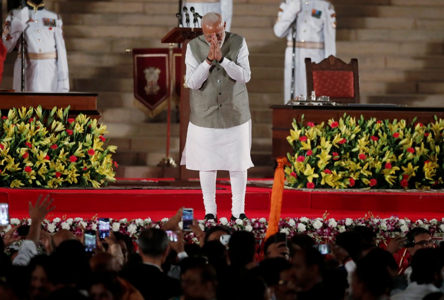 Indian Prime Minister Narendra Modi gestures towards supporters after his oath during a swearing-in ceremony at the presidential palace in New Delhi on May 30. - Reuters