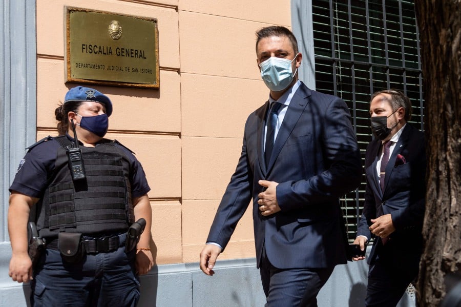 The former lawyer of late football great Diego Maradona, Matias Morla (C), arrives at the prosecutor's office in San Isidro, Buenos Aires Province, to testify in the case investigating the death of the Argentine star almost a year ago, on October 25. - AFP PIC