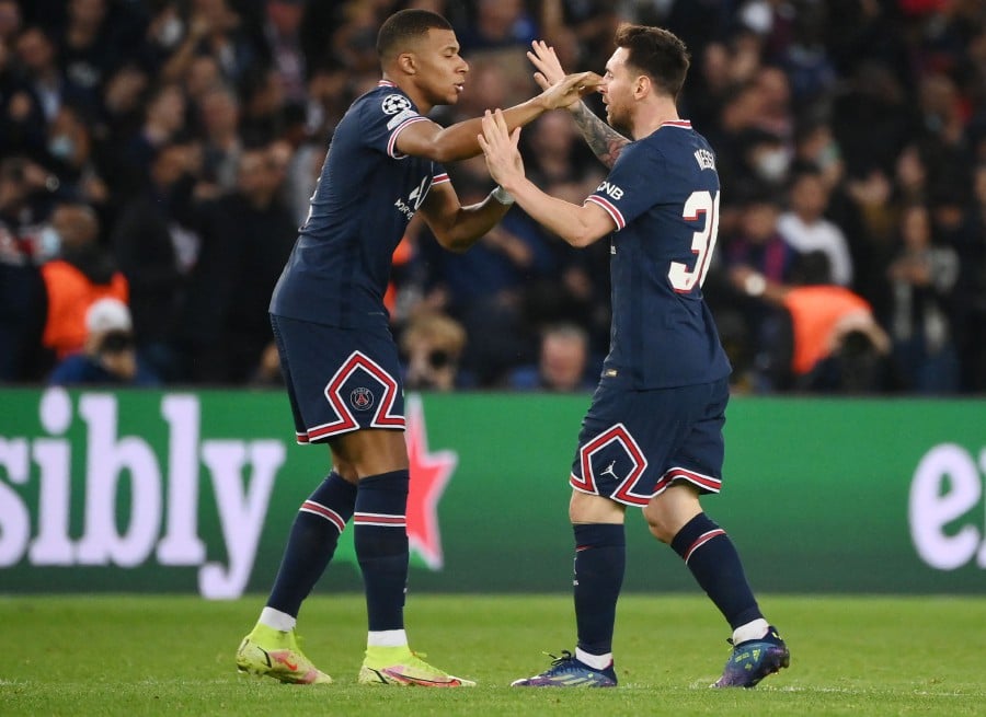  Paris Saint-Germain's Argentinian forward Lionel Messi (R) celebrates with Paris Saint-Germain's French forward Kylian Mbappe after scoring his team's second goal during the UEFA Champions League first round group A football match between Paris Saint-Germain's (PSG) and RB Leipzig, at The Parc des Princes stadium, in Paris, on October 19.- AFP PIC