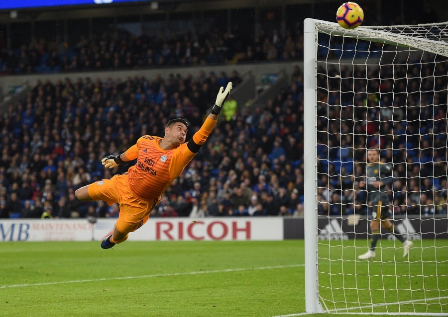 Cardiff City's English-born Filipino goalkeeper Neil Etheridge dives but watches the ball pass over his crossbar during the Premier League match against Leicester City at Cardiff City Stadium, south Wales on November 3, 2018. AFP PIC