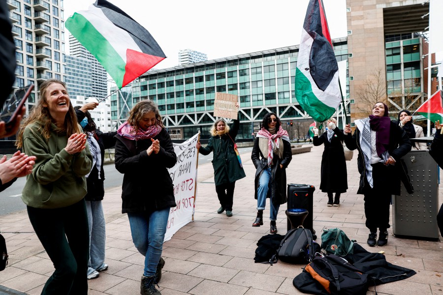 Demonstrators hold Palestinian flags during a protest outside the court building, amid the court case of human rights groups who seek to block the Dutch government from exporting F-35 fighter jet parts to Israel, which they claim enables war crimes in the besieged Gaza Strip, in The Hague, the Netherlands. REUTERS pic