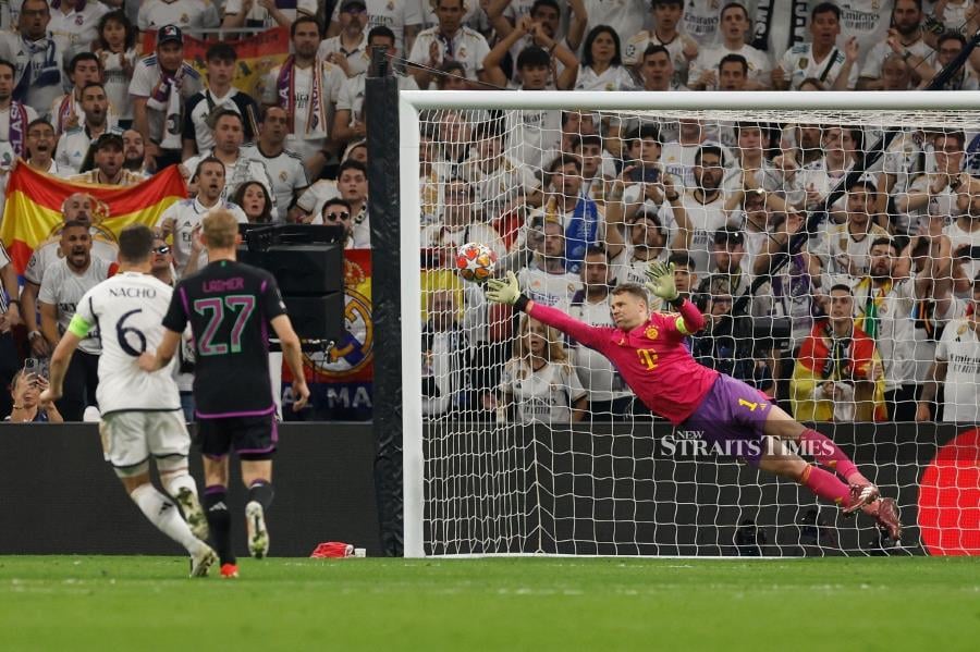 Bayern Munich goalkeeper Manuel Neuer deflects the ball during Wednesday’s Champions League semi-final second leg match against Real Madrid at the Santiago Bernabeu Stadium in Madrid. - AFP PIC