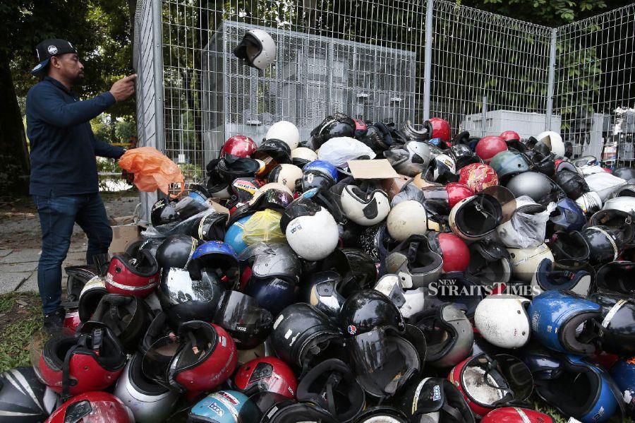 KUALA LUMPUR: Road Transport Department personnel collecting old helmets turned in by the public to the department at the Madani government's One-Year Anniversary Programme in Bukit Jalil National Stadium. - NSTP/AIZUDDIN SAAD
