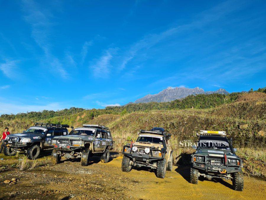 4x4s against a backdrop of Mount Kinabalu.x4s against a backdrop of Mount Kinabalu.
