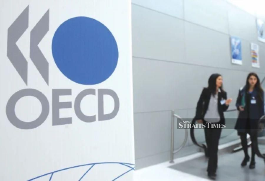 The OECD raised its 2024 world economic growth forecast Monday but warned that the Middle East conflict posed a risk, with disruptions in Red Sea shipping threatening to increase consumer prices.