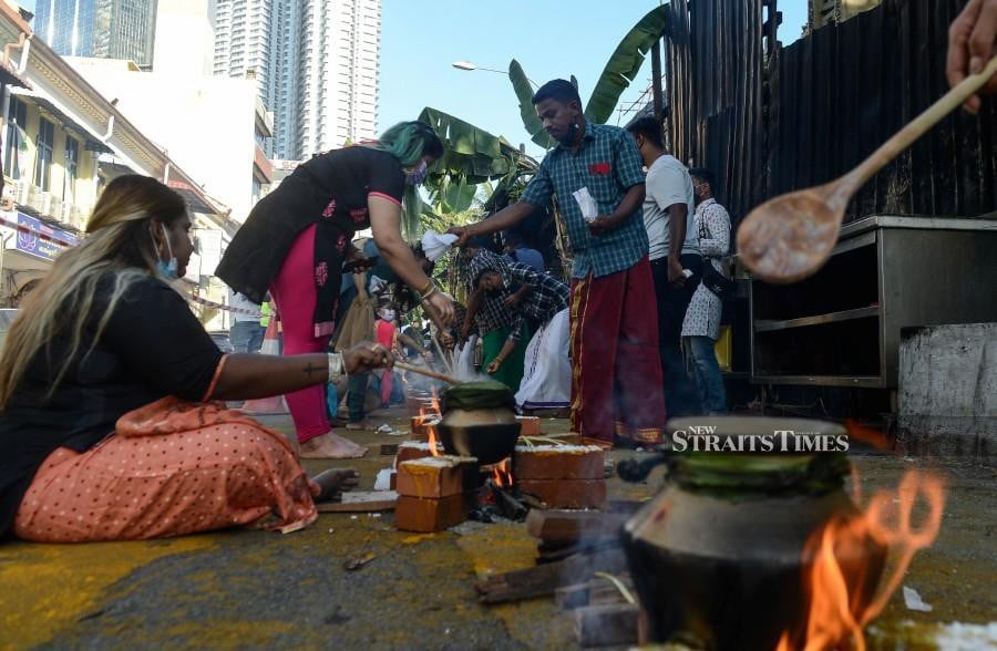 Devotees cooking milk as part of the Pongal celebration in Brickfields. - NSTP/HAZREEN MOHAMAD