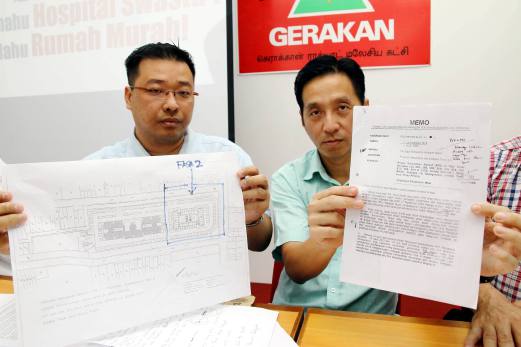 Penang Gerakan secretary Oh Tong Keong (right) with Penang BN youth chief, Hng Chee Wey (right) show documents pertaining to development in Taman Manggis, George Town. Pix by Amir Irsyad Omar 