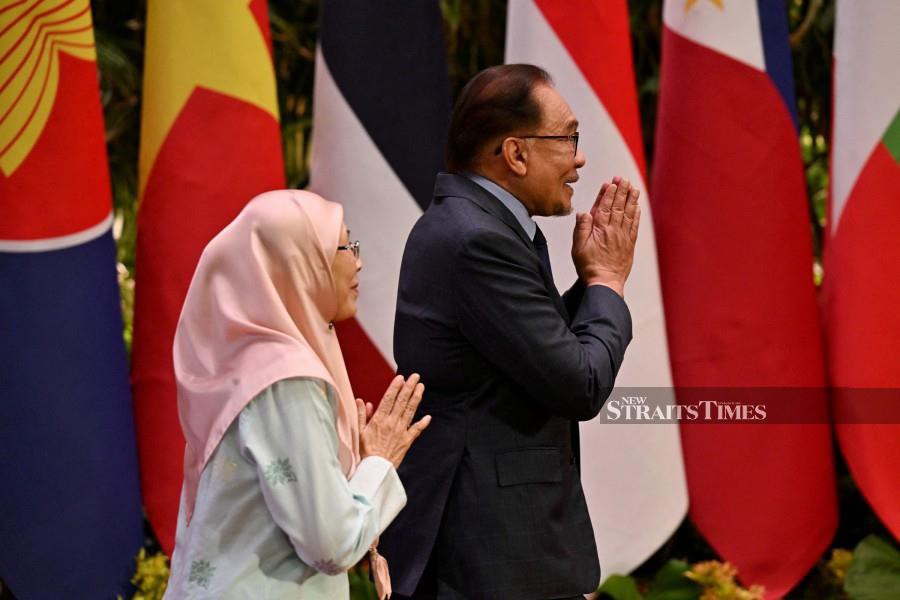  Prime Minister Datuk Seri Anwar Ibrahim (R) and wife Datuk Seri Wan Azizah Wan Ismail arrive for the Asean Summit in Jakarta. - REUTERS PIC