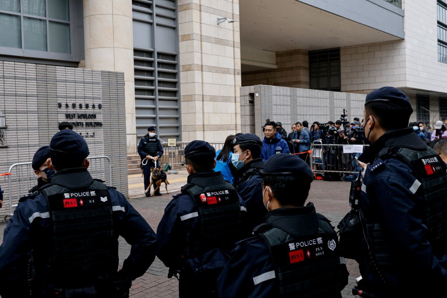 Police stand guard outside West Kowloon Magistrates' Courts during the trial of the now-defunct pro-democracy newspaper Apple Daily and its founder, Jimmy Lai, in Hong Kong. - REUTERS PIC