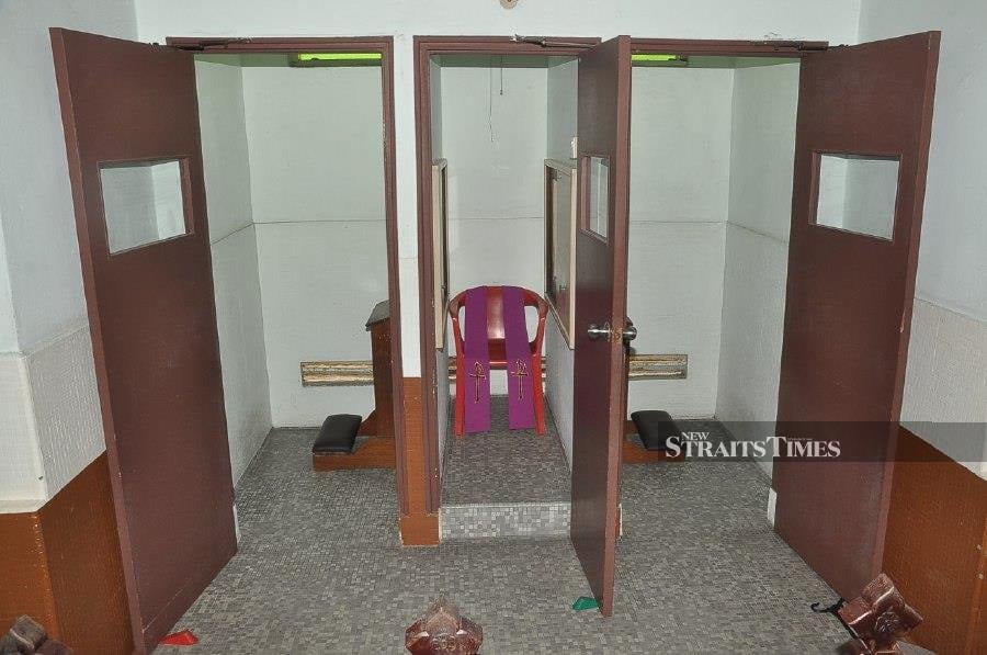 Empty confessionals in church due to MCO. - NSTP/VINCENT D'SILVA