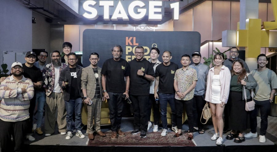Media Prima Audio chief executive officer, Nazri Noran (sixth from left), and Khairy Jamaluddin (eighth from left) together with some of the podcasters who will be participating in the upcoming KL PodFest 2024. - Pic by Sadiq Sani