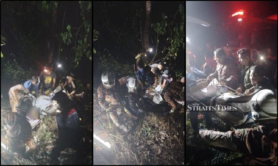 Firemen attend to victims of the crash in Gunung Inas. -Pix courtesy of Fire and Rescue Department 