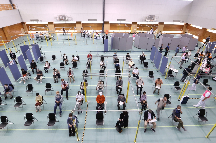People gather to receive the Moderna coronavirus vaccine at a newly-opened mass vaccination centre in Toyoake City, Aichi prefecture on May 24, 2021. - AFP PIC