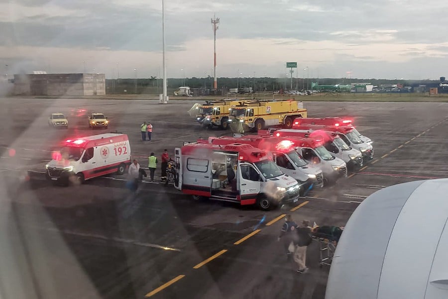 This UGC picture taken on July 1, 2024 and released as a courtesy by passenger Claudio Fernandez Arbes shows ambulances next to an Air Europa Boeing 787-9 Dreamliner after it made an emergency landing in Natal, in northern Brazil. - AFP PIC