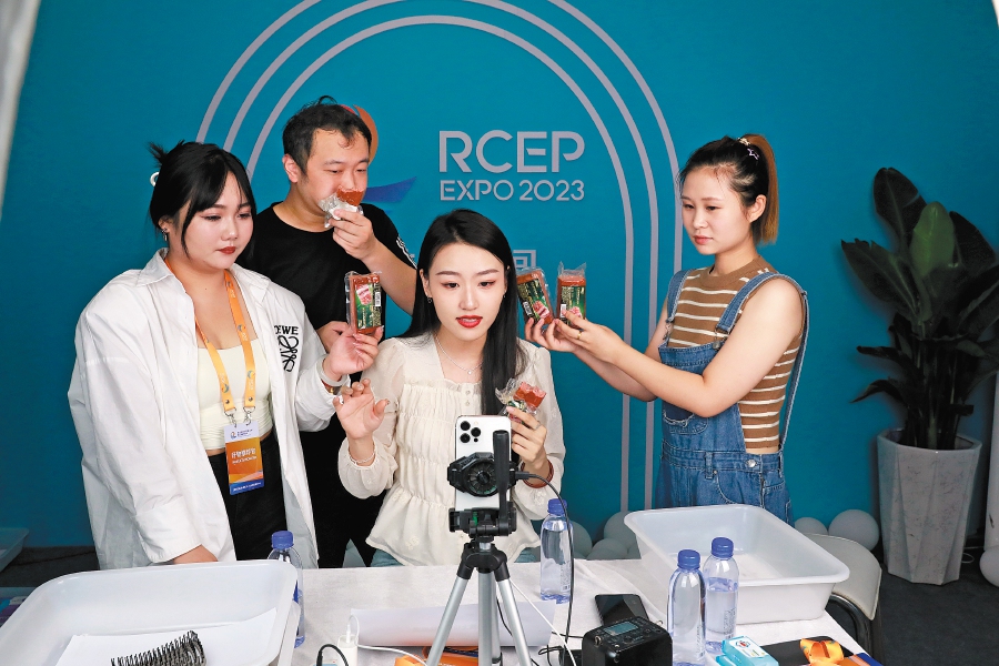 Presenters promote food products from a livestreaming studio at the RCEP (Shandong) Import Expo in Linyi, Shandong province, on August 18. - Courtesy pic